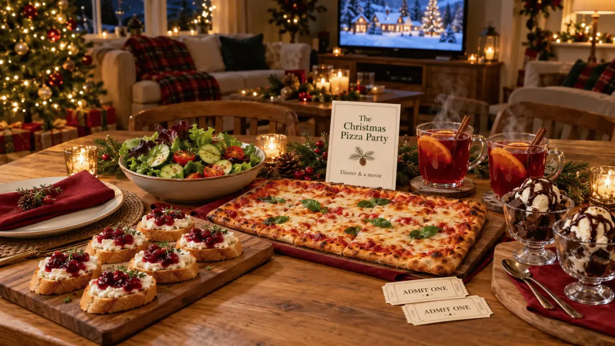 The Christmas Pizza Party table with pizza, salad, crostini, sundaes and cinema tickets